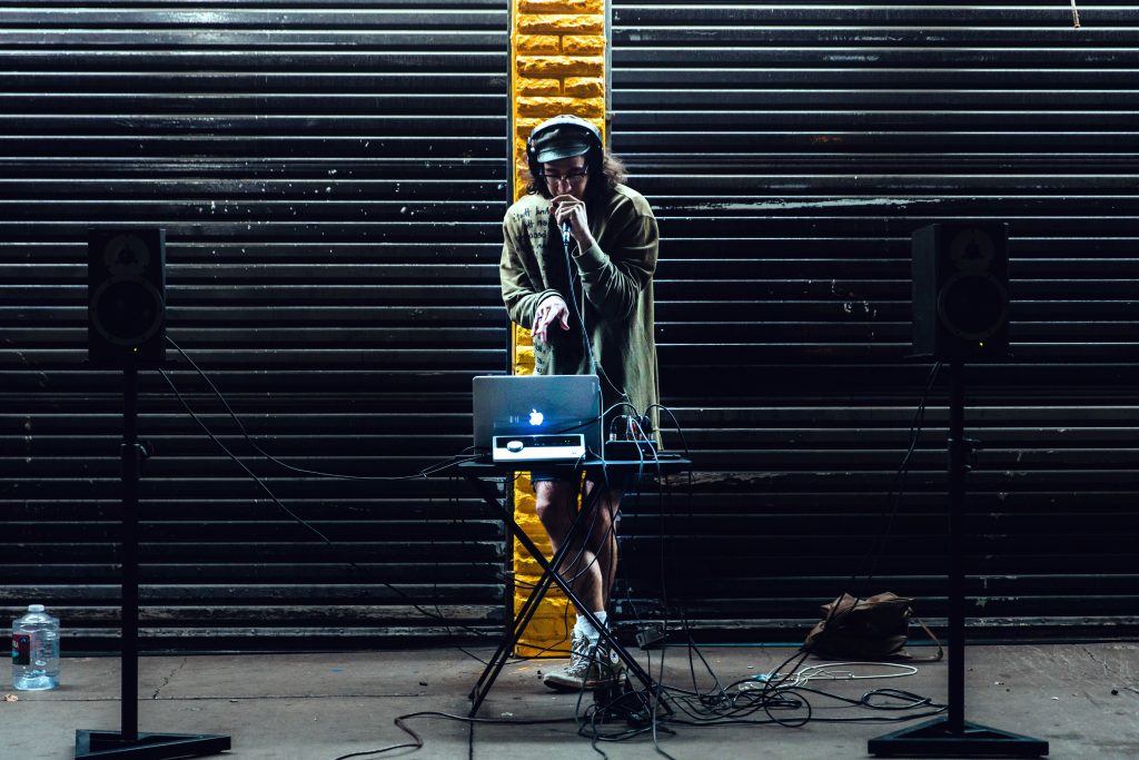 person on stage with low profile speakers